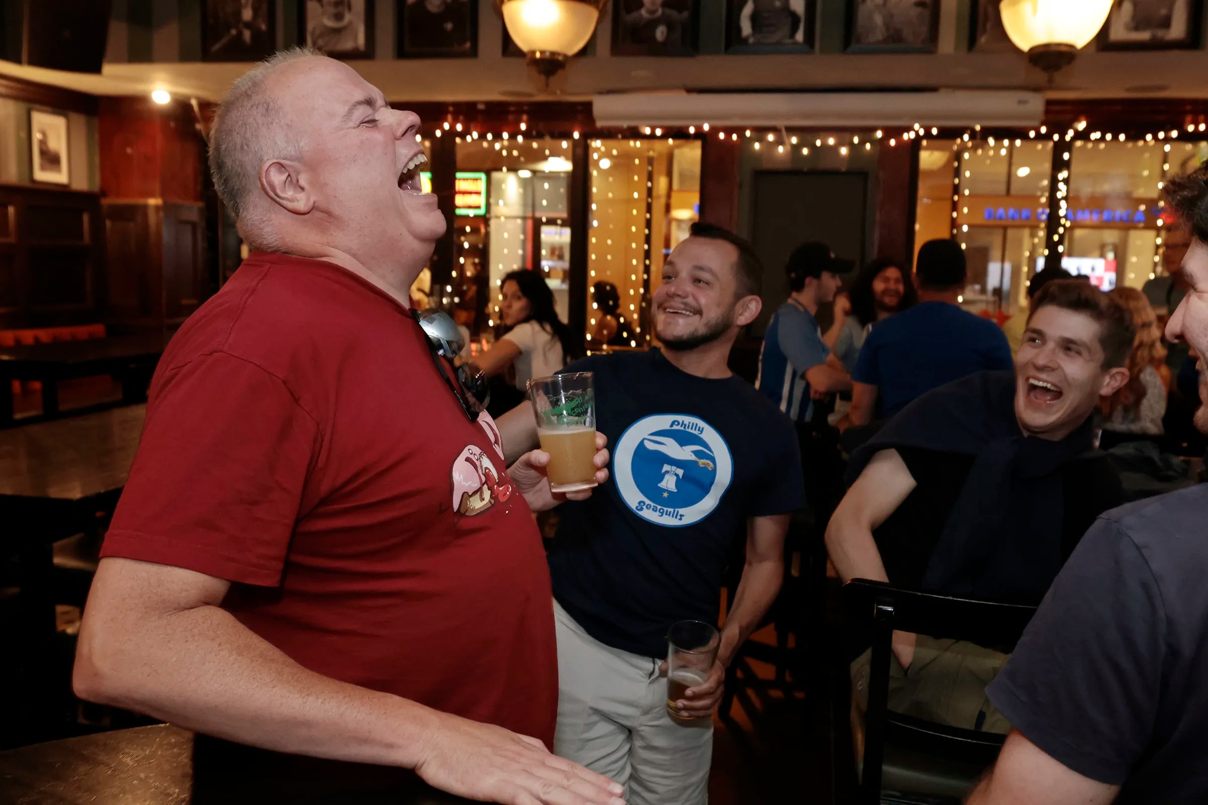 Steve Maehl (left) of Oconomowoc, Wisc., laughs as Philly Seagulls president John Fitzpatrick and Dan Peck of Brighton, England, (right) look on during the supporter meetup, to kickoff the summer series weekend, at Fadó Irish Pub in Phila., Pa. on Thursday, July 20, 2023.