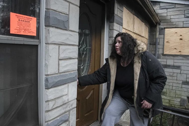 Tiffany Wilson Lane, 42, enters her burned out home in Ogden, PA February 12, 2017.