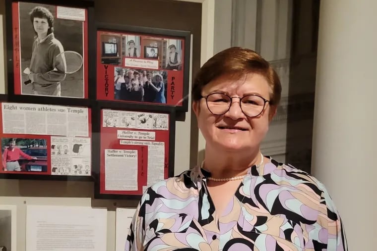 Rollin Haffer, the former Temple badminton player who was the lead plaintiff in a class-action Title IX lawsuit against the school, in front of an exhibit on “Title IX: Activism On and Off the Field"