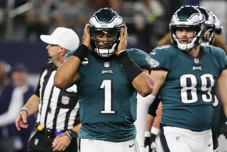 Eagles quarterback Jalen Hurts covers his ears during the second quarter against the Dallas Cowboys on Monday, September 27, 2021 in Arlington, Texas.