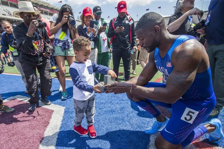 Justin Gatlin gives the watch he was awarded for winning USA vs. the World Men 4×100 to his nephew at the Penn Relays on April 28, 2018.
