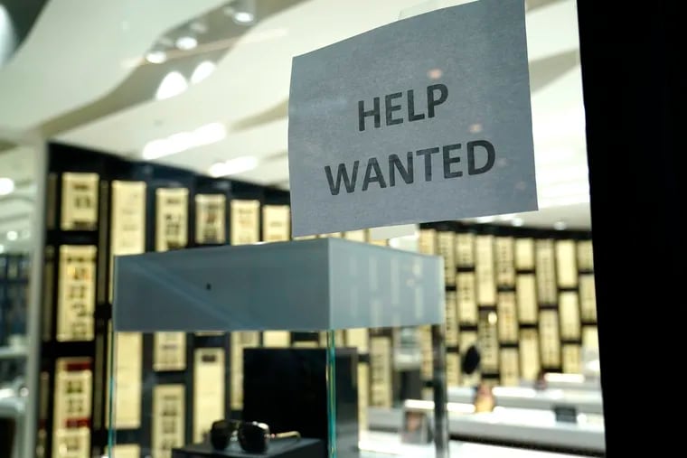 A Help Wanted sign is posted at a Designer Eyes store at Brickell City Centre, Friday, Nov. 6, 2020, in Miami.