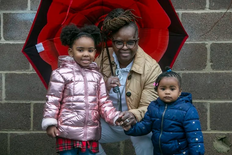 Cynthia Robinson with grandchildren London, 3 (left) and Zain, 15 months, outside her home on Germantown Avenue on Nov. 30, 2020.