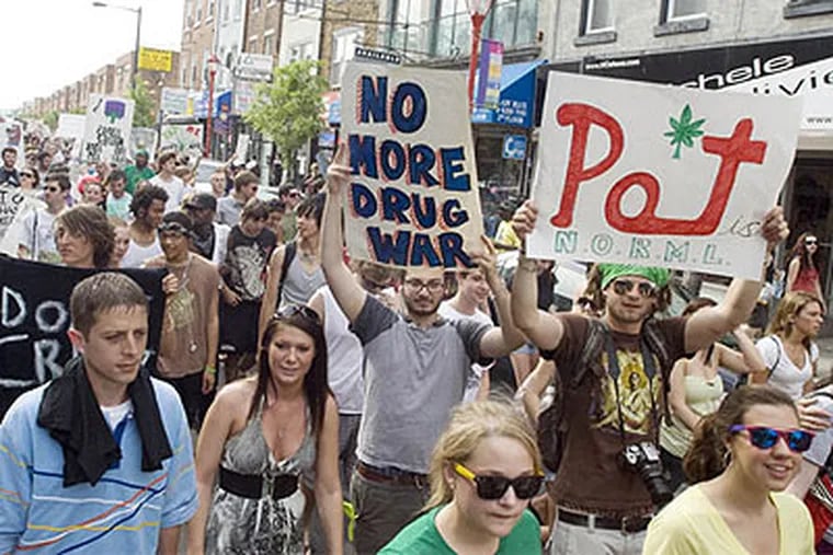Hundreds of protestors marched on South Street on May 1 to support the legalization of marijuana. Pot still isn't legal in Philly, but anyone caught with an ounce or less faces only a summary offense starting today. (Ron Tarver / Staff Photographer)