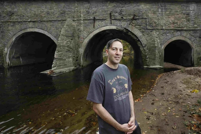 Jason Sherman in front of the King's Highway Bridge, the oldest surviving road span in the country, built in 1697 to cross the Pennypack Creek.