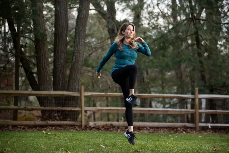 Fitness columnist Ashley Greenblatt demonstrates a jumping lunge in her backyard in Voorhees, N.J.