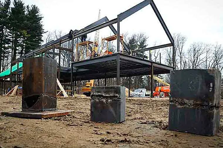 Sections of steel beams that have been cut with a have been cut with a torch sit in front of the Quaker meeting house construction site at 100 E. Mermaid Lane  on Janurary 11, 2013.  (RON TARVER / Staff Photographer )