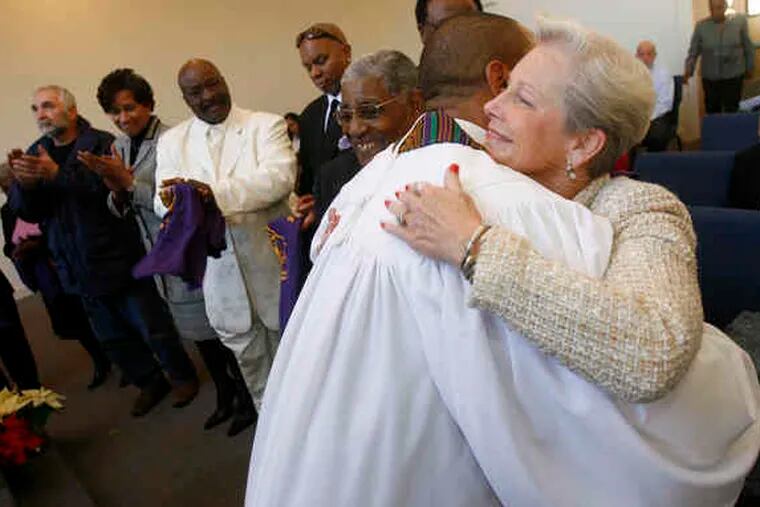 AFTER FIRE destroyed historic Greater Mt. Pisgah Church, in Haddonfield, N.J., there was a communitywide effort to rebuild it. Yesterday, at a reopening service, Rev. Mark-Anthony Rassman, Sr. (foreground), thanked many who helped, including Haddonfield Mayor Tish Columbi (right).