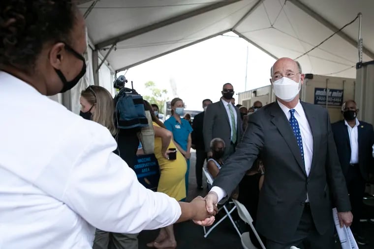 Gov. Tom Wolf (center) tours the Jefferson mobile vaccine site at St. Raymond of Penafort Catholic Church. Wolf said he will not be requiring masks for K-12 students, like Gov. Phil Murphy is in New Jersey.