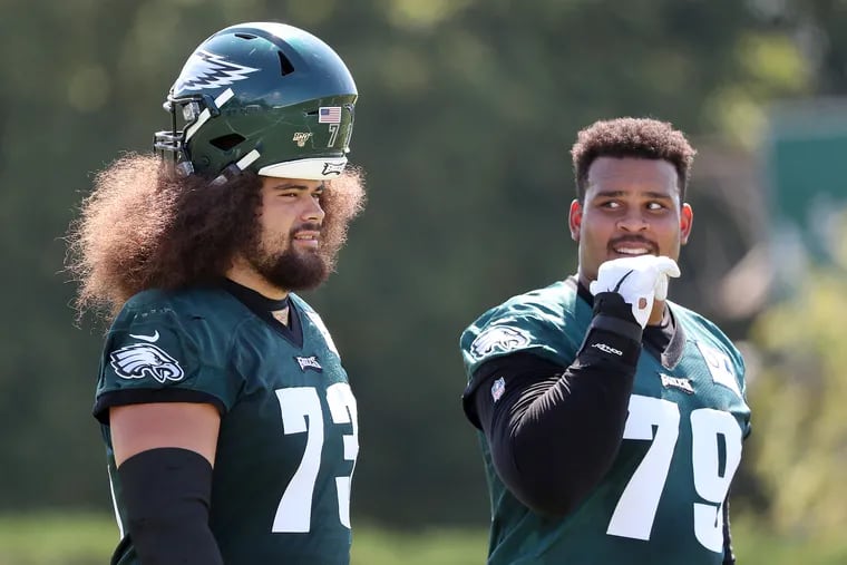 Eagles offensive guards Isaac Seumalo, left, and Brandon Brooks, right, walk off the field after Eagles training camp in Philadelphia, PA on August 12, 2019. Brooks is rehabbing a torn Achilles' tendon.