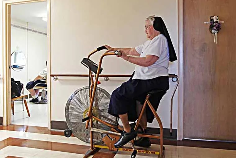 Sister Maria Patris uses the exercise bike that is out in the hallway outside the beauticians room on the fourth floor of Camilla Hall. Exercise equipment for the sisters is now scattered in hallways throughout the building. The new construction will allow for them to be concentrated in one exercise room. roomOf the Immaculate Heart of Mary’s 883 sisters - whose average age is 72 - almost a quarter live in retirement at Camilla Hall. Over the next ten years, that number is expected to grow. To accommodate them, Camilla Hall, a small 52-year old retirement home for IHM nuns at Immaculata University, is expanding and being converted into a modern retirement facility with room for art and massage therapy, medical suites and communal dining hall, among other amenities.  Construction is underway. I'm getting a tour of facility and will hopefully talk to some residents.  Contacts: Sister Ann Veronica  05/08/2013 ( MICHAEL BRYANT / Staff Photographer )