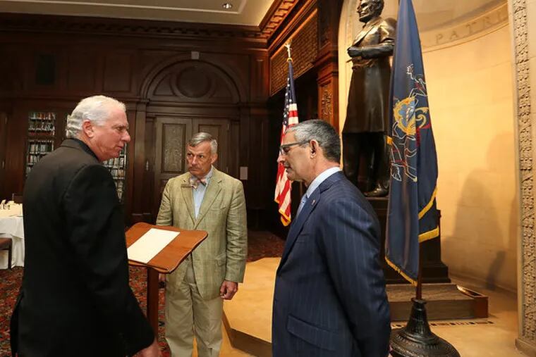 Around Lincoln’s lectern, Fred Stein (left) of the Creative Group and Bob Ciarruffoli (right) of
World Meeting of Families 2015 talk with James Mundy of the Union League, where the historic
piece is being kept while on loan. (DAVID MAIALETTI / Staff Photographer)