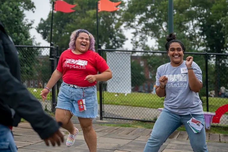 Sheila De La Cruz (left) joins in game of keep-it-up with Fab Youth Philly team leader Johana Rahman and others in the McPherson Square playground in Kensington. A play captain, De La Cruz is one of the teenagers hired by Fab Youth Philly to help facilitate safe and educational play in city neighborhoods for young children.