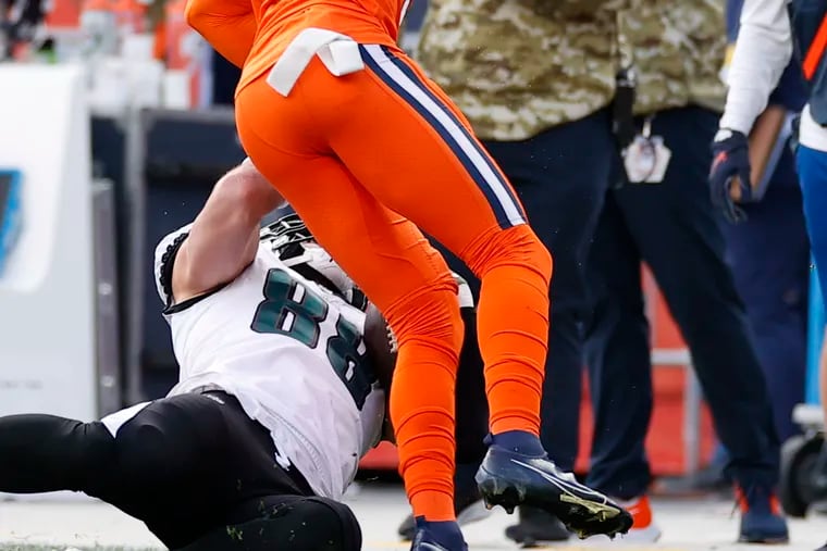 Eagles tight end Dallas Goedert gets hit by Denver Broncos free safety Justin Simmons in the first quarter on Sunday, November 14, 2021 in Denver.  Goedert left the game after the hit.