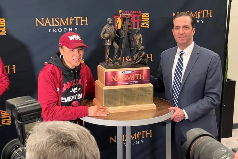 Dawn Staley (left) with the Naismith Women's Coach of the Year Award trophy.