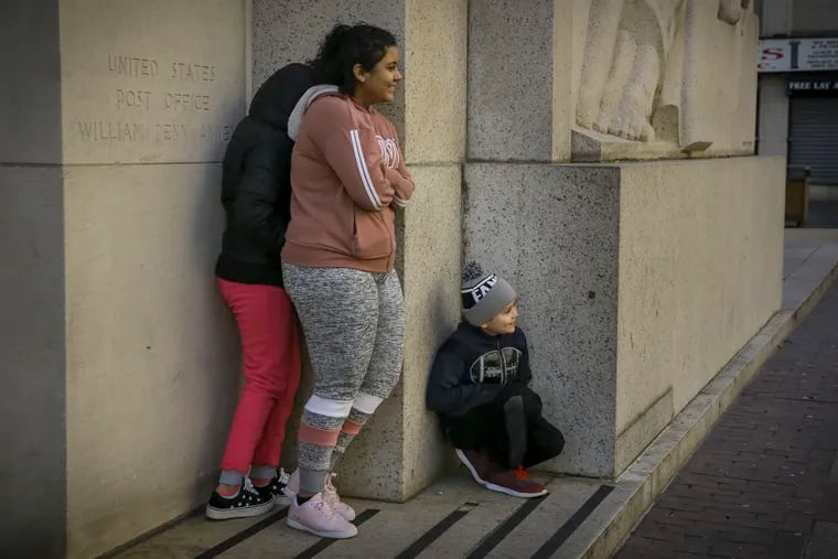 Members of the Martinez family huddle in the corner of the Robert Nix Building at 9th and Market St. in Center City Philadelphia on a cold Thursday morning, January 31, 2019. Temperatures dropped below zero during arctic blast.