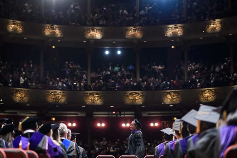 A student walks during Penn Law's graduation ceremony in 2017.