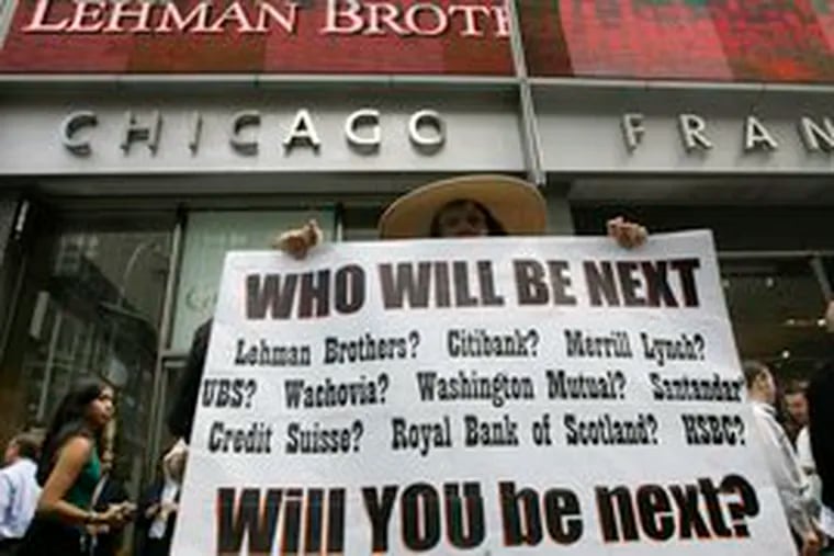 A sign held up in front of Lehman Brothers headquarters in New York yesterday underscores growing credit-crisis fears.