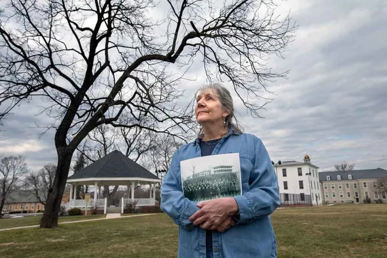 Barbara Landis of the Cumberland County Historical Society, holding a photograph of the 1892 class, has shed some light on the remains’ identity