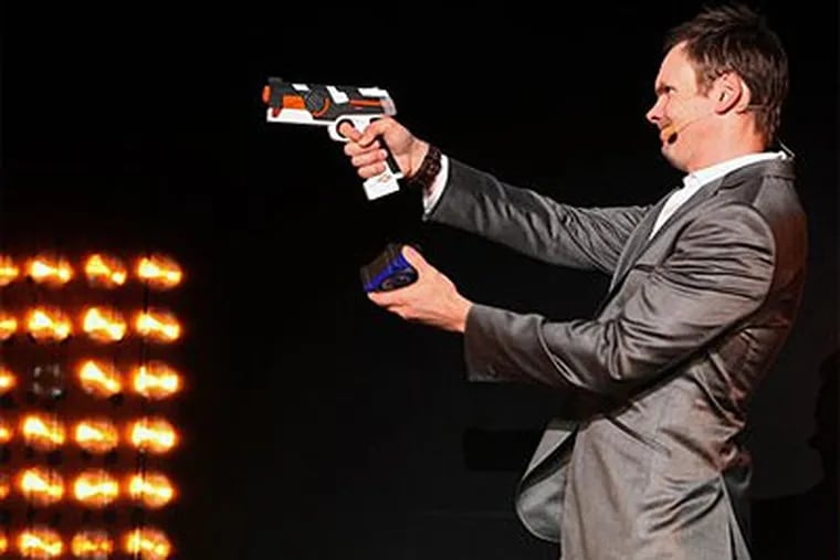 In this photograph taken by AP Images for Ubisoft, Joel McHale plays "Battle Tag" onstage at the Ubisoft E3 Press Conference on Monday, June 14, 2010 in Los Angeles. (Casey Rodgers / AP Images for Ubisoft)