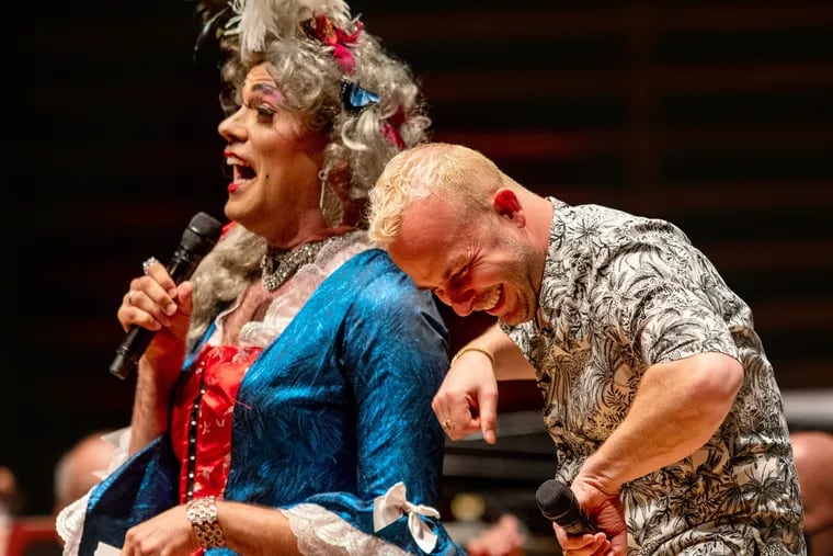 Philadelphia Orchestra music director Yannick Nézet-Séguin (right) with local drag royalty Martha Graham Cracker during the orchestra's Pride Concert in Verizon Hall at the Kimmel Center on June 2.