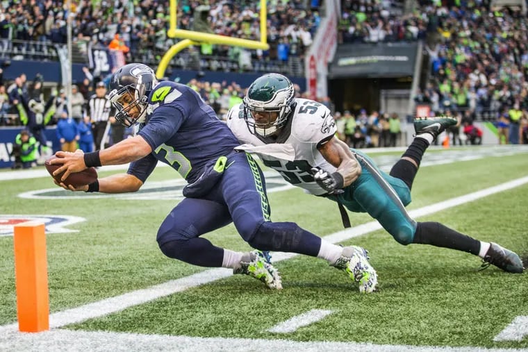 The Eagles' Nigel Bradham can't keep Seahawks QB Russell Wilson from scoring on 15-yard trick pass thrown by wide receiver  Doug Baldwin.