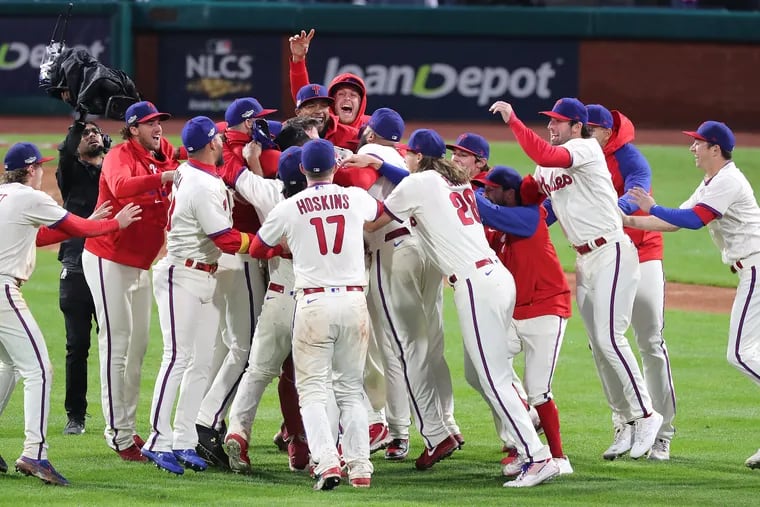 The Phillies celebrate their 4-3 win over the Padres in Game 5 of the NLCS to advance to the World Series.
