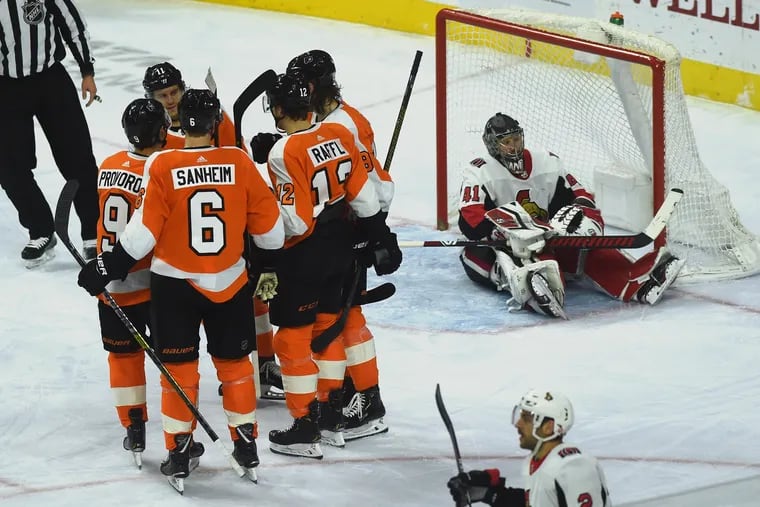 Ottawa goalie Craig Anderson sits in the crease as the Flyers celebrate a second period goal by Michael Raffl on Monday.