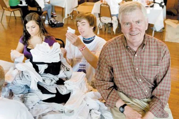 Student volunteers at Chestnut Hill College pair up donations. Tom Costello (foreground) founded the nonprofit to give clean socks to the homeless. (Clem Murray / Staff Photographer)
