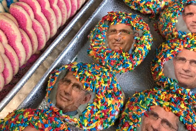 Behold the butterscotch "COVID cream”-filled donuts dipped in “quarantini sprinkles” boasting the face of  Dr. Anthony  Fauci, director of the National Institute of Allergy and Infectious Diseases. They sell at JB Bakery in Burlington in tribute to the man who briefs the American public almost daily on the pandemic.
