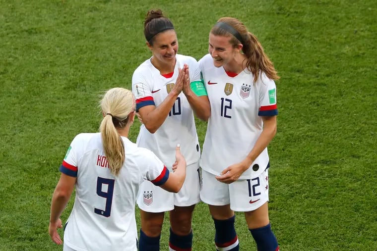 Carli Lloyd (middle) celebrating with Lindsey Horan and Tierna Davidson (right) after scoring the opening goal during the Women's World Cup Group F soccer match between the United States and Chile on Sunday.