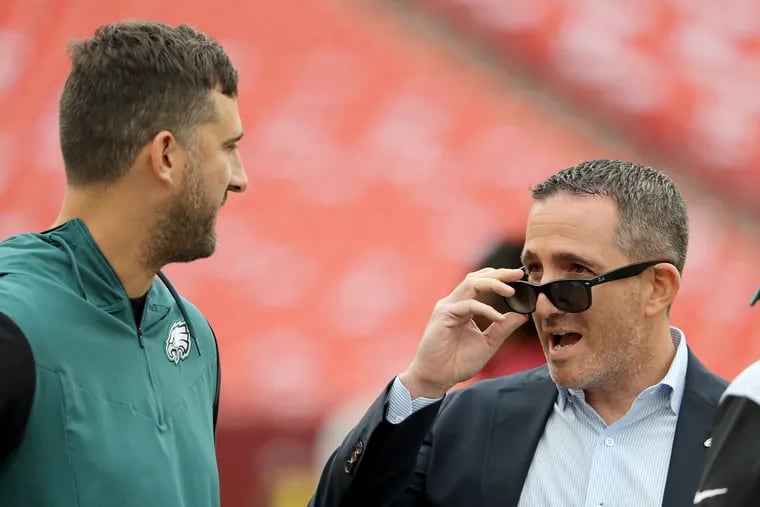 Eagles coach Nick Sirianni (left) and GM Howie Roseman talking before the Eagles played the Commanders on Sept. 25.