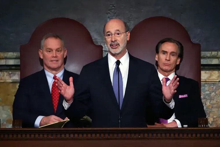 Gov. Tom Wolf, center, delivers his budget address for the 2016-17 fiscal year to a joint session of the Pennsylvania House and Senate, as the speaker of the state House of Representatives, state Rep. Mike Turzai, R-Allegheny, left, and Lt. Gov. Mike Stack, right, listen at the State Capitol in Harrisburg, Tuesday, Feb. 9, 2016.