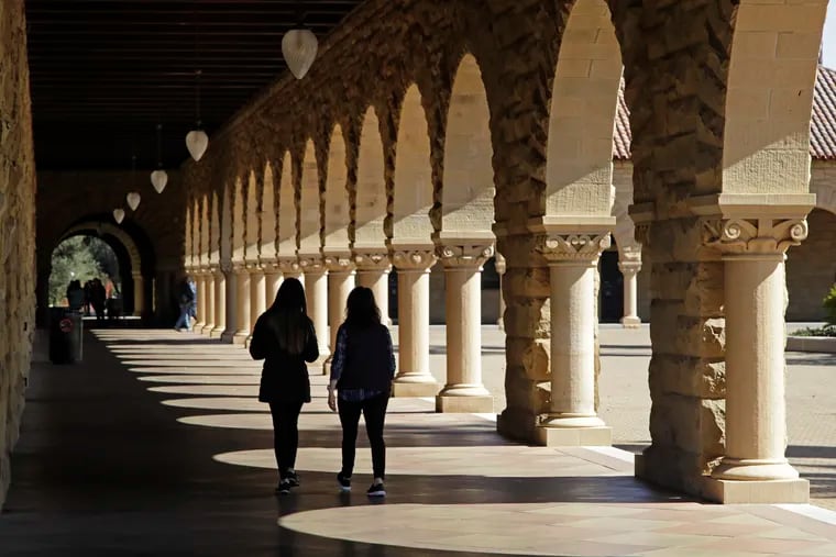 In this March 14, 2019, file photo students walk on the Stanford University campus in Santa Clara, Calif.  Paying off student debt is a key benefit that employers can use to attract workers.  (AP Photo/Ben Margot, File)