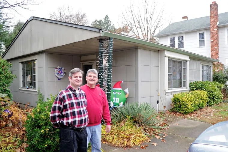Carl Gainsborough (left) and Karl Kernagis outside their Haddonfield home, a Lustron house made almost entirely of metal. The 65-year-old house is one of about 1,600 Lustrons left in the country.