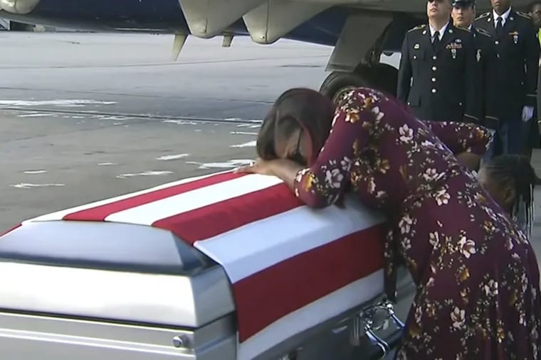 Myeshia Johnson cries over the casket of her husband, Sgt. La David Johnson, who was killed in an ambush in Niger, upon his body’s arrival in Miami.