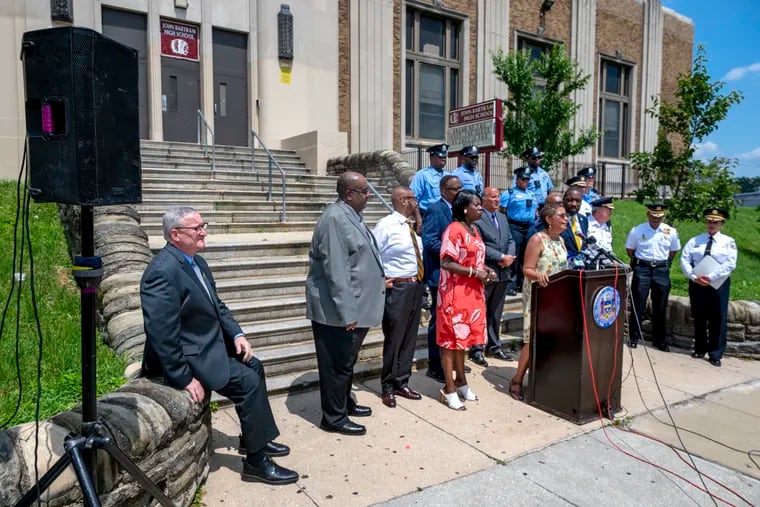 City Councilmember Maria Quiñones Sánchez, at lectern, appears with other members of City Council, Mayor Jim Kennery, far-left, and other officials Monday at John Bartram High School to announce funding for at least 100 security cameras near schools impacted by gun violence.