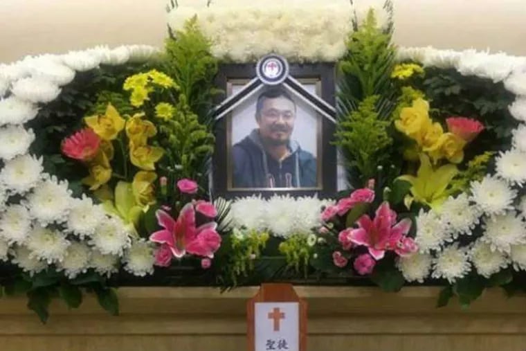 A portrait of Korean adoptee Phillip Clay is displayed at a memorial service held in Korea.