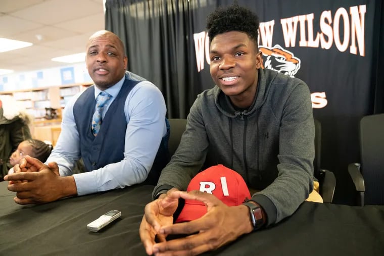 Woodrow Wilson's Stanley King (right) and his coach, Preston Brown, talk after King committed on Wednesday to Rutgers.