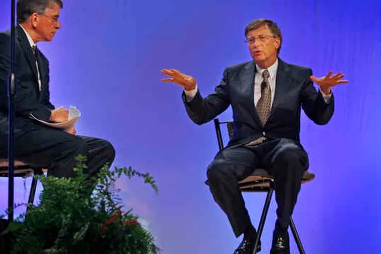 Bill Gates (right) responds toa questionby North Carolina House Speaker Joe Hackneyat the Convention Center.