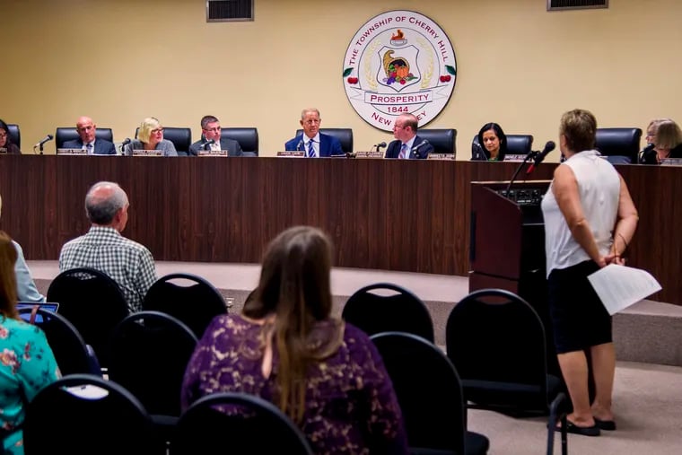Cherry Hill Mayor Chuck Cahn (center) answers questions for resident Donna Topham (right) as she speaks during the public comment period during the Cherry Hill Township Council meeting Sept. 9, 2019, after they introduced an ordinance to ban short term rentals like Airbnb, following the issues at the Airbnb former home of Muhammad Ali.