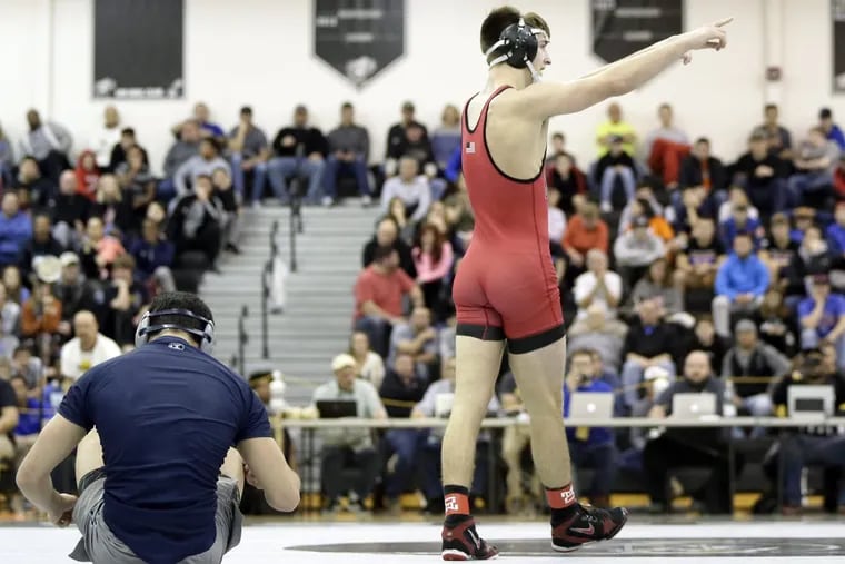 At 185 lbs., Kingsway’s Quinn Kinner points to the stands after pinning St. Augustine’s Connor Kraus during the Region 8 wrestling finals at Egg Harbor Township on Saturday.