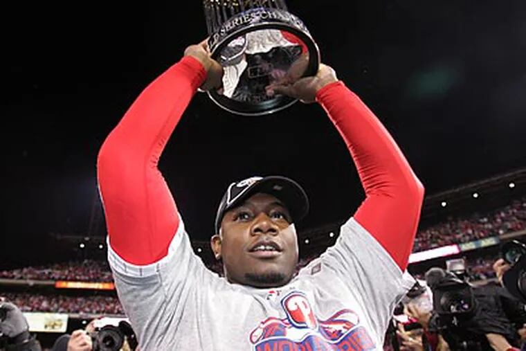 Ryan Howard holds the World Series trophy after the Phillies' triumph last October. (Barbara L. Johnston/Staff file photo)
