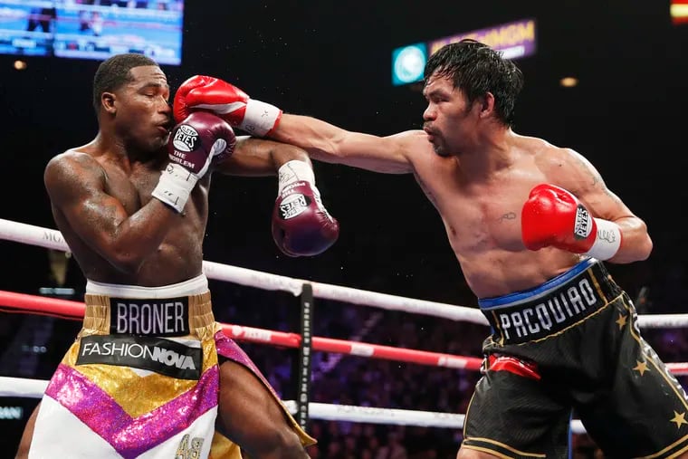 FILE - In this Saturday, Jan. 19, 2019, file photo, Manny Pacquiao, right, fights Adrien Broner in a welterweight championship bout in Las Vegas. A spokesman for Pacquiao says the famed fighter's Los Angeles home was robbed at about the time he was in the ring with rival Adrien Broner in Las Vegas. Spokesman Mike Quinn confirmed the burglary to NBC News. Los Angeles police said a burglary was reported about 4:15 p.m. Sunday, Jan. 20, 2019. in the Larchmont neighborhood. (AP Photo/John Locher, File