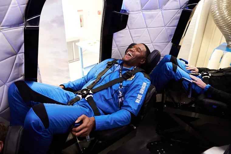 In an image provided by Blue Origin, ex-NFL star Michael Strahan is seen during training last week for Saturday's mission.