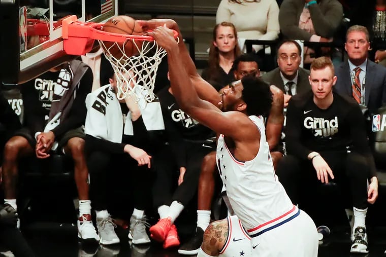 Joel Embiid dunks in the fourth quarter against the Nets on Saturday. The All-Star was utterly dominant.