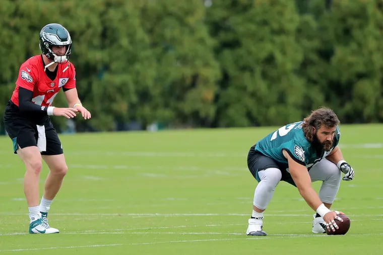 Eagles quarterback Carson Wentz (left) takes a snap from center Jason Kelce at practice. The Eagles are preparing to play the Los Angeles Rams on Sunday.