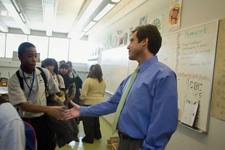 Mastery CEO Scott Gordon shakes the hand of Pickett Campus eighth grader Breond Wright. (Ed Hille / Staff Photographer)
