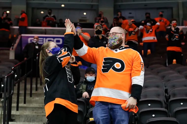 Flyers fans celebrate Flyers left wing Joel Farabee's first period goal against the Washington Capitals on March 7, the first day fans were allowed back into the Wells Fargo Center in more than a year.