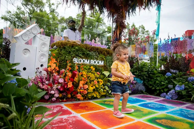 Ava Woodall, 1, dances at the Rhythm in Bloom by Jennifer Designs at the 2022 Flower Show at FDR Park in Philadelphia, Pa., on Saturday.